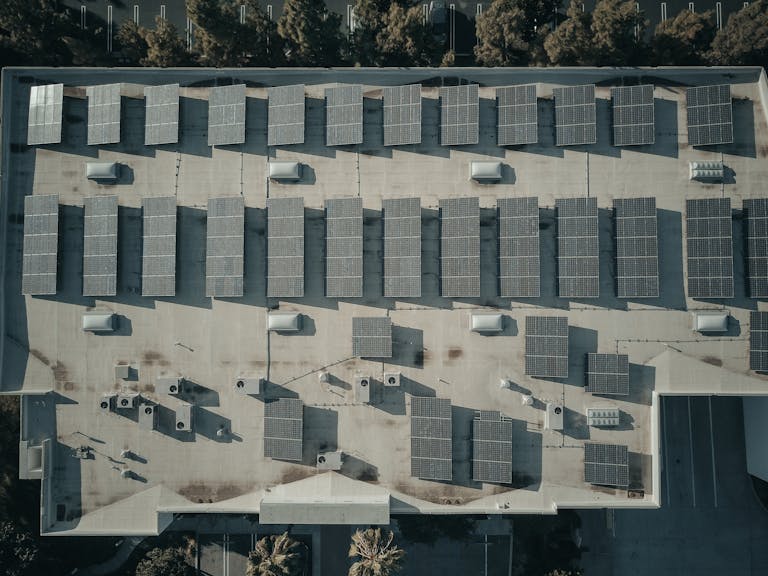 Discover the efficiency of solar energy with this aerial shot of solar panels on a rooftop.